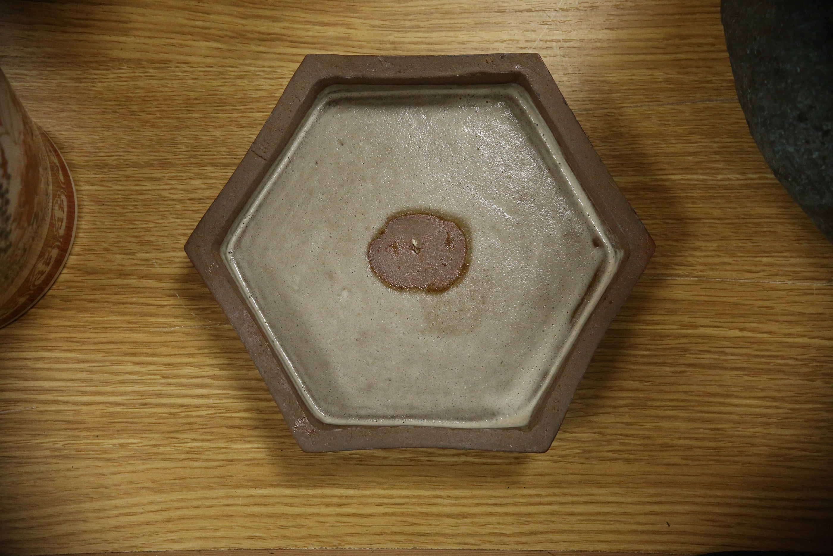 A Japanese studio tenmoku glazed hexagonal box and cover, unmarked, 18cm wide. Condition - good